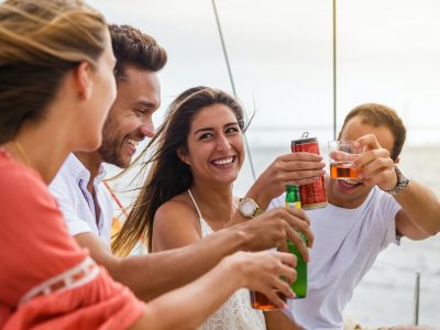 Group of friends having fun in boat in river